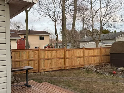 Wood privacy fence across a backyard
